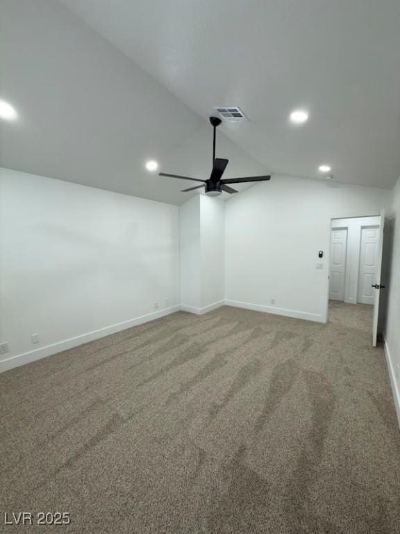 spare room featuring lofted ceiling, a ceiling fan, baseboards, and carpet floors