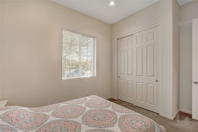 bedroom with a closet, baseboards, and carpet floors