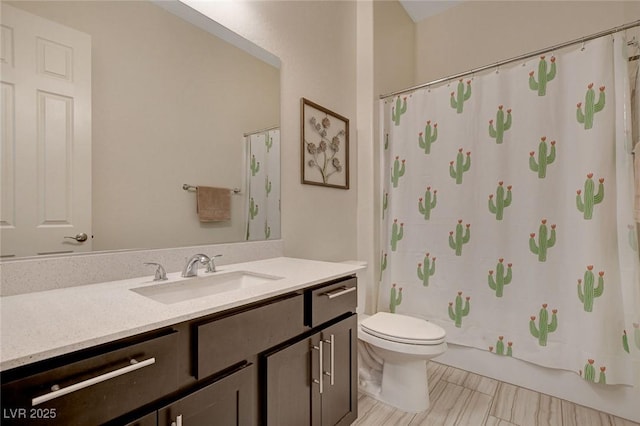 bathroom featuring toilet, shower / tub combo with curtain, and vanity