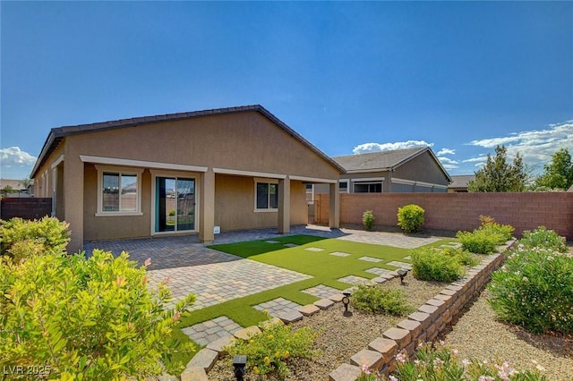 back of property featuring a patio, a fenced backyard, and stucco siding