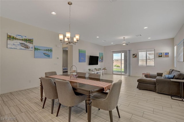 dining space featuring recessed lighting and a chandelier