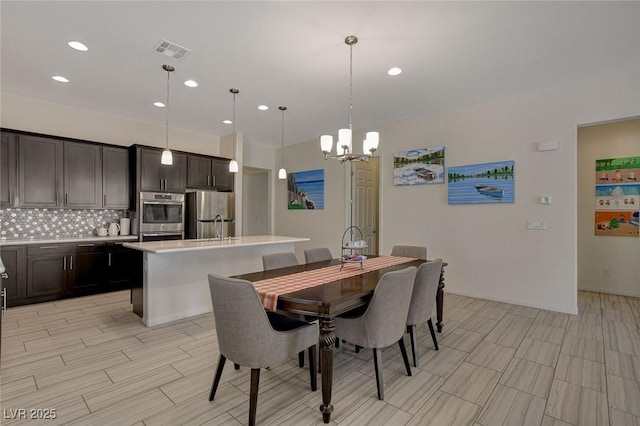 dining room with recessed lighting, visible vents, wood finish floors, and a chandelier