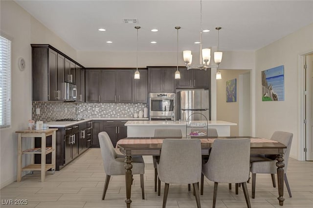 dining area featuring an inviting chandelier, recessed lighting, light wood-style floors, and visible vents