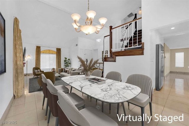 dining area with lofted ceiling, light tile patterned flooring, and a chandelier