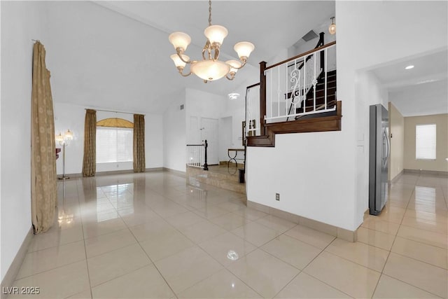 interior space featuring light tile patterned floors, stairway, baseboards, and a chandelier