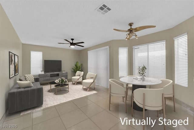 dining space featuring light tile patterned floors, visible vents, baseboards, and ceiling fan