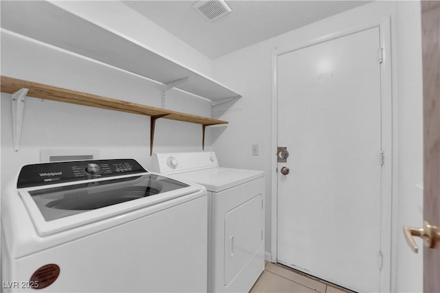 washroom with washer and clothes dryer, laundry area, visible vents, and light tile patterned flooring