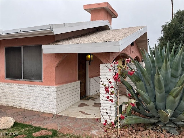 view of side of home with stucco siding