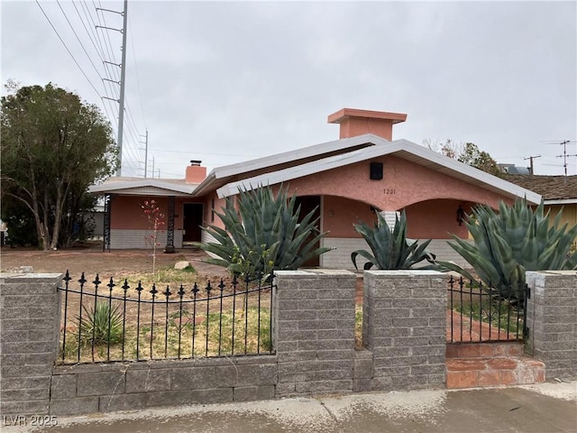 mid-century inspired home with a gate, a fenced front yard, and a chimney