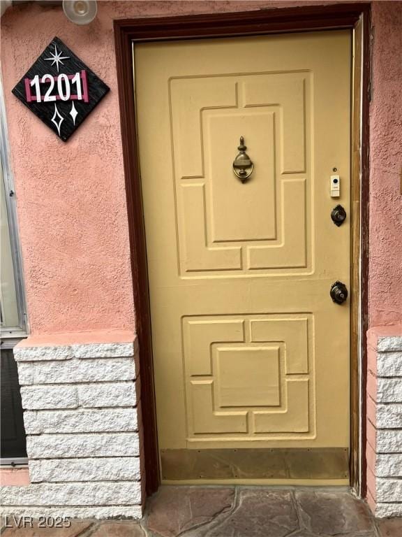 entrance to property with stucco siding