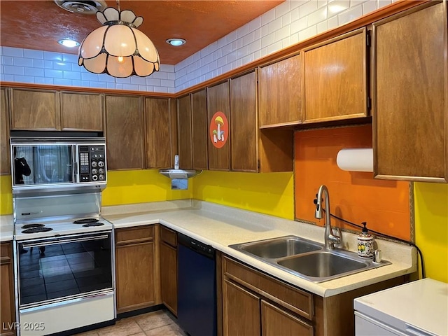 kitchen with dishwasher, light countertops, range with electric stovetop, hanging light fixtures, and a sink