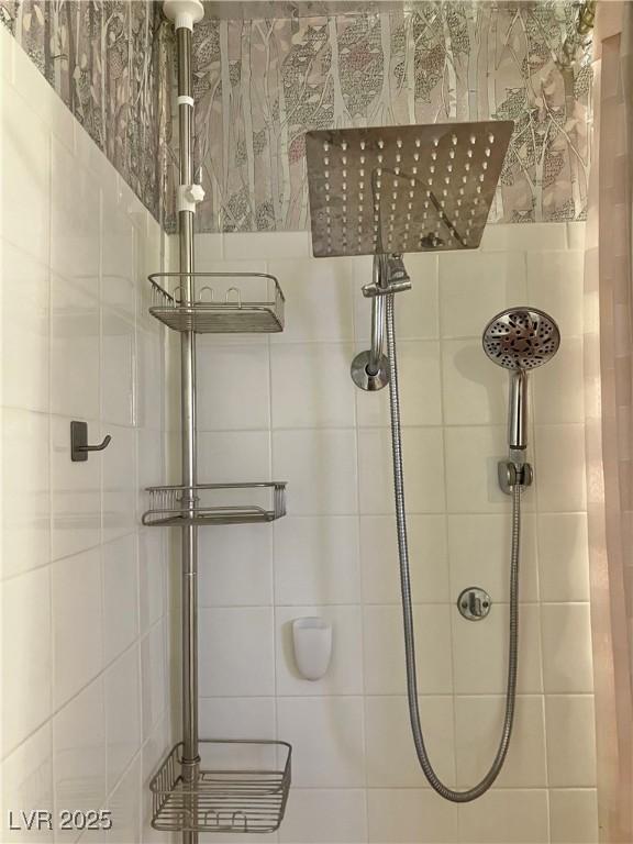 full bath with a tile shower