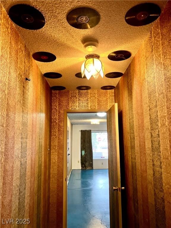 hallway with a textured ceiling