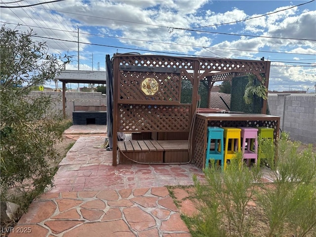 view of patio / terrace featuring fence