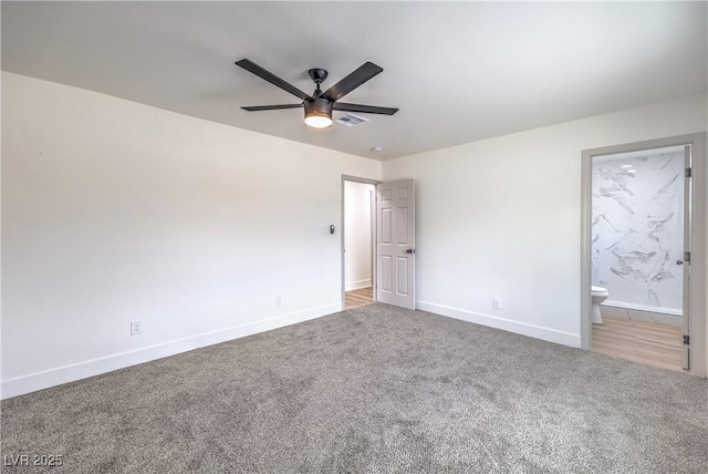 unfurnished bedroom with visible vents, connected bathroom, baseboards, carpet flooring, and a ceiling fan