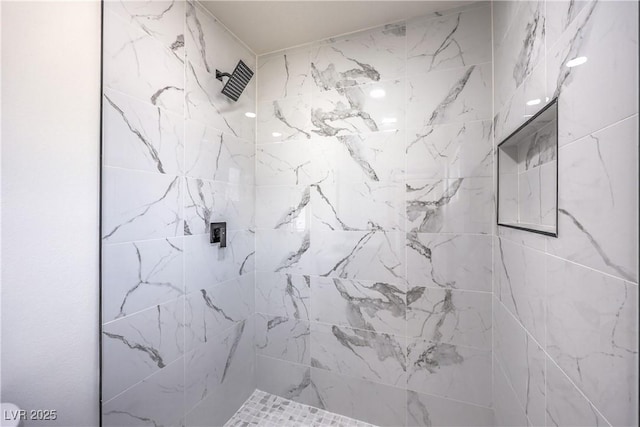 full bath featuring a tile shower