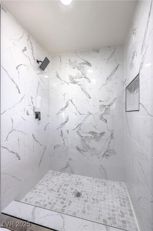 bathroom with a tile shower