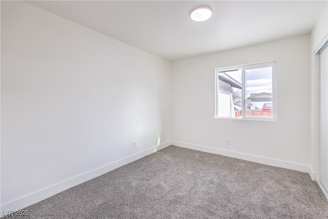 carpeted empty room with baseboards