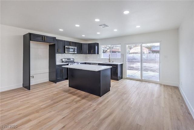 kitchen with visible vents, appliances with stainless steel finishes, light countertops, and light wood-style floors