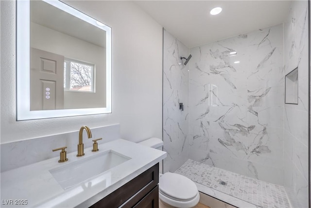 full bathroom featuring a marble finish shower, toilet, and vanity