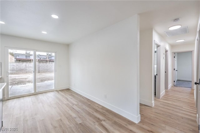 empty room featuring recessed lighting, visible vents, baseboards, and light wood-style floors