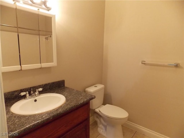 bathroom featuring tile patterned floors, toilet, vanity, and baseboards