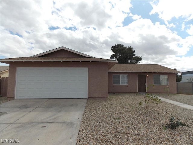 ranch-style home with stucco siding, driveway, roof with shingles, and an attached garage