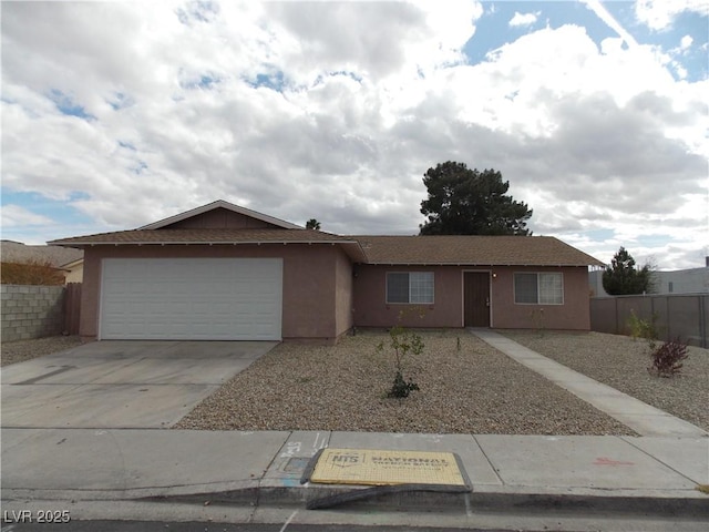 ranch-style home featuring an attached garage, fence, and stucco siding