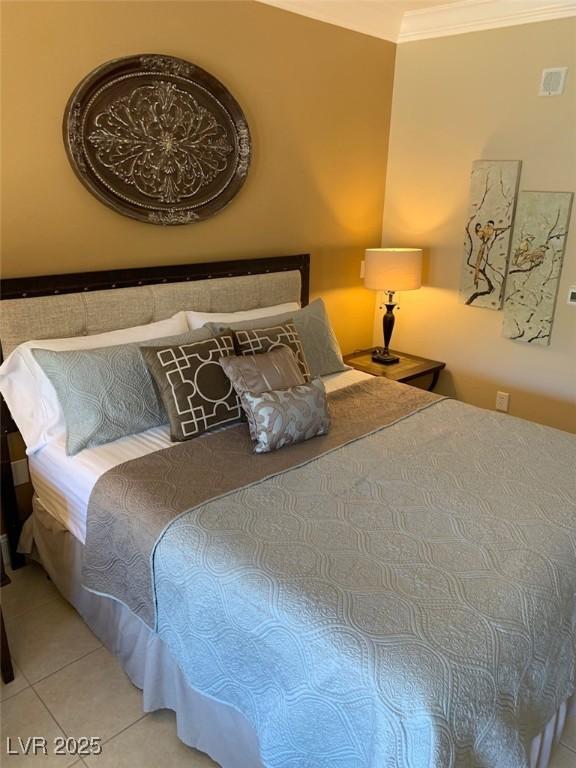 bedroom featuring tile patterned floors and ornamental molding