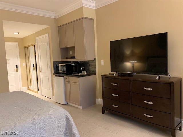 bedroom with light tile patterned flooring, crown molding, and a sink