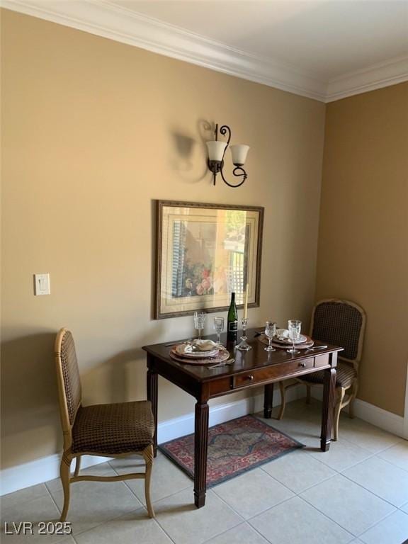 dining space featuring light tile patterned flooring, baseboards, and ornamental molding