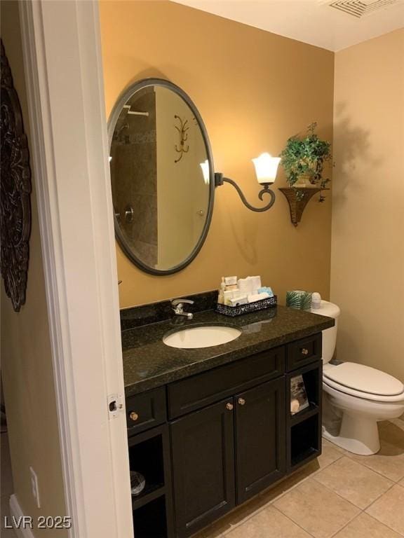 bathroom with tile patterned flooring, toilet, and vanity