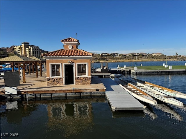 view of dock with a gazebo and a water view