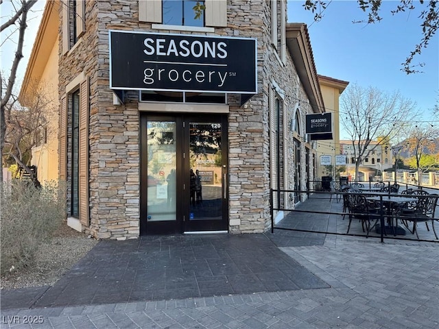 entrance to property featuring stone siding