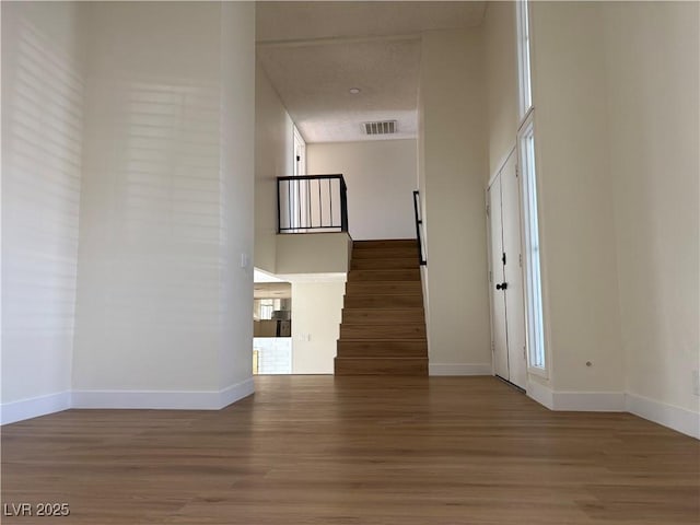 interior space with visible vents, baseboards, and wood finished floors