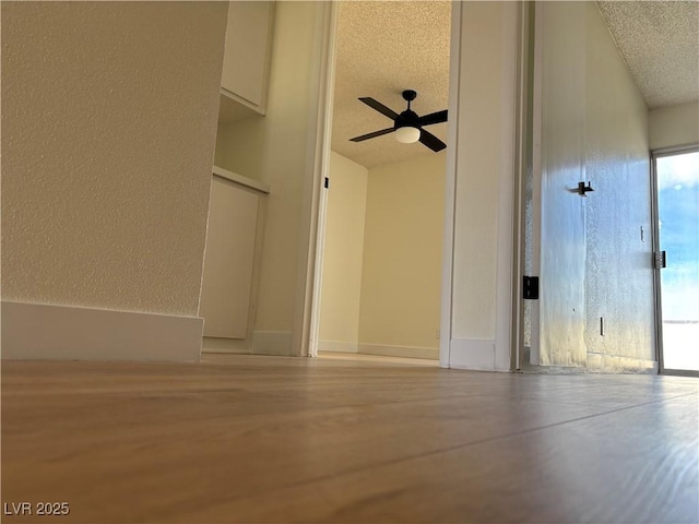 interior space featuring baseboards and a textured ceiling