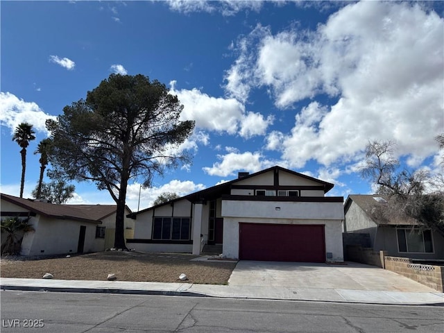 view of front of home with stucco siding and concrete driveway