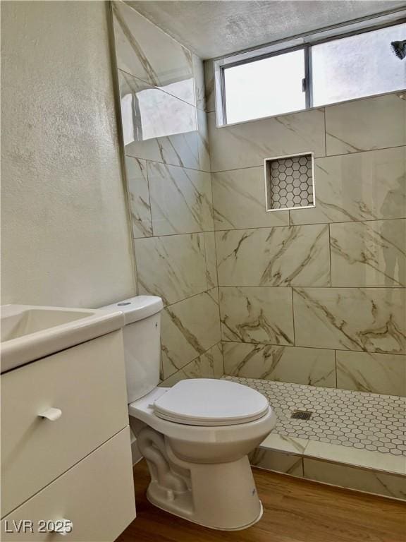 full bathroom with vanity, toilet, wood finished floors, and a shower stall