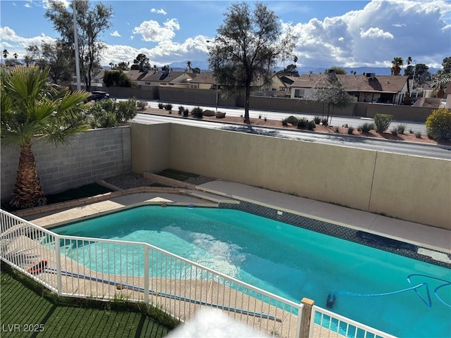 view of pool featuring a residential view and a fenced backyard