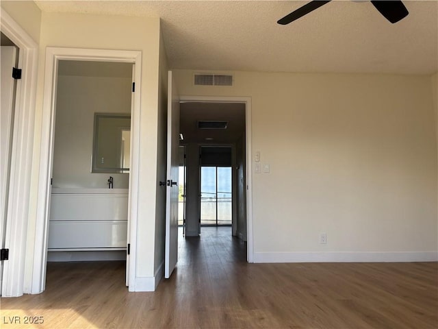 interior space featuring visible vents, baseboards, and wood finished floors