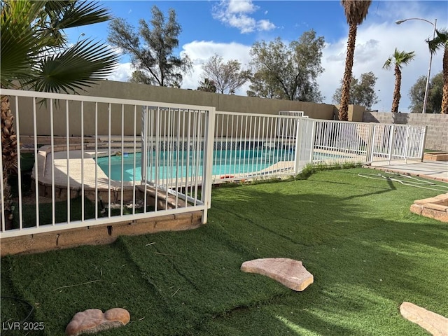 view of swimming pool featuring a fenced in pool, a yard, and fence