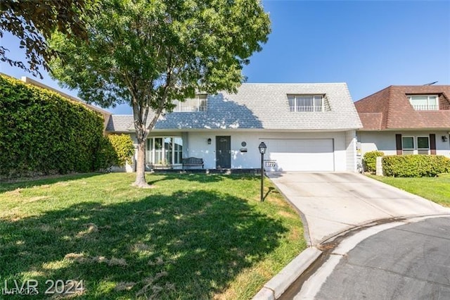 view of front of house with concrete driveway, a front yard, and a shingled roof