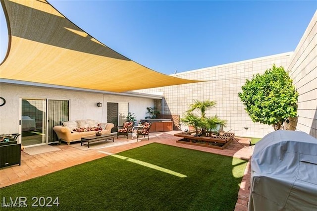 view of yard featuring a jacuzzi and a patio area