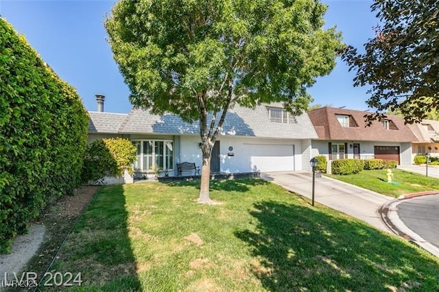 view of front of house with driveway, an attached garage, a front lawn, and a shingled roof