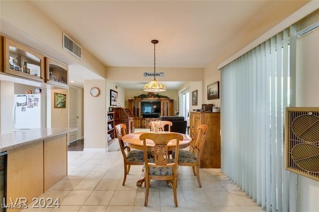 dining area featuring light tile patterned floors and visible vents