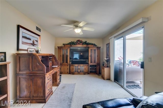 living room featuring visible vents, light colored carpet, and ceiling fan