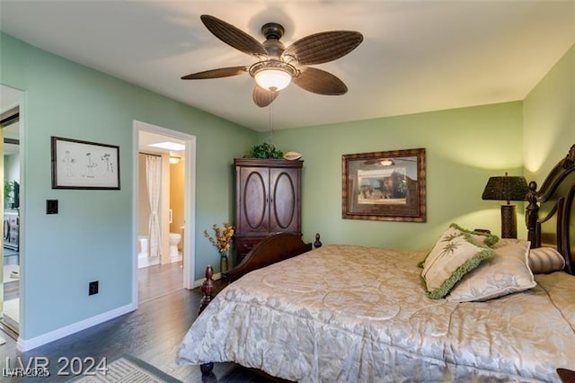 bedroom with connected bathroom, baseboards, wood finished floors, and a ceiling fan