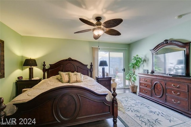 bedroom with access to exterior and a ceiling fan