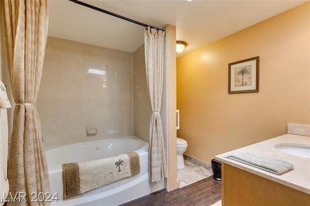 bathroom featuring vanity, toilet, wood finished floors, and shower / bath combo with shower curtain