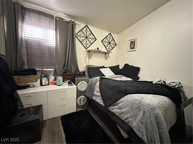 bedroom featuring lofted ceiling and wood finished floors